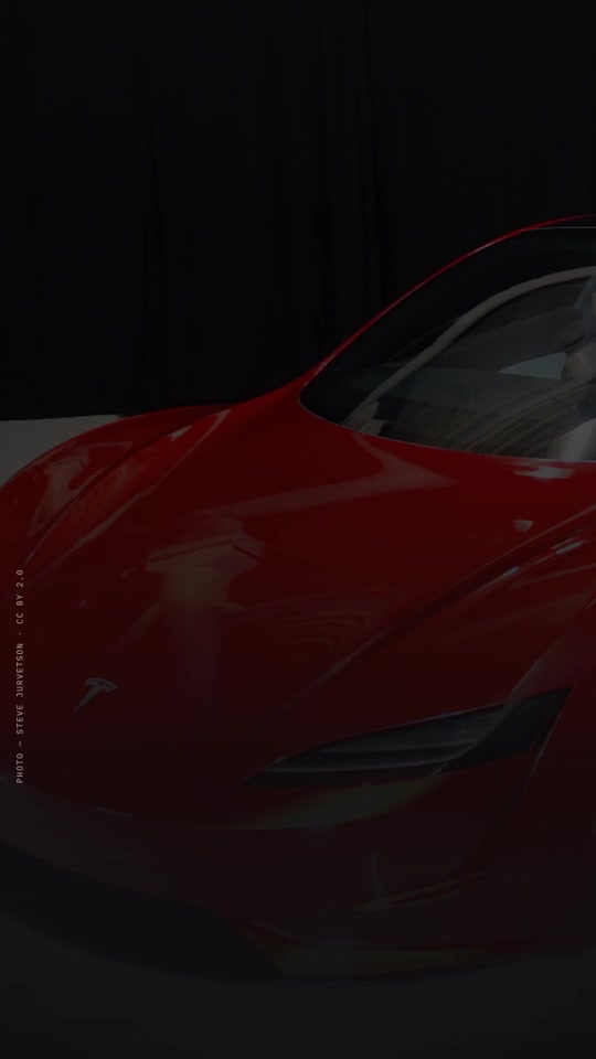 Opening frame: a red Tesla Roadster in a dark studio. Photo credit in the frame: Steve Jurvetson, CC BY 2.0.